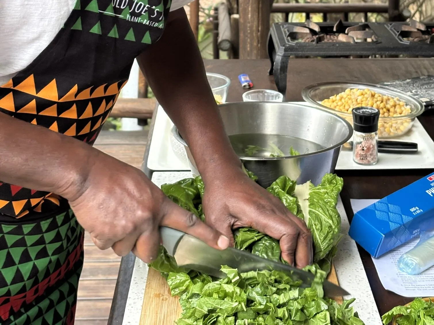 Chopping fresh greens in an Old Joe's Kaia apron