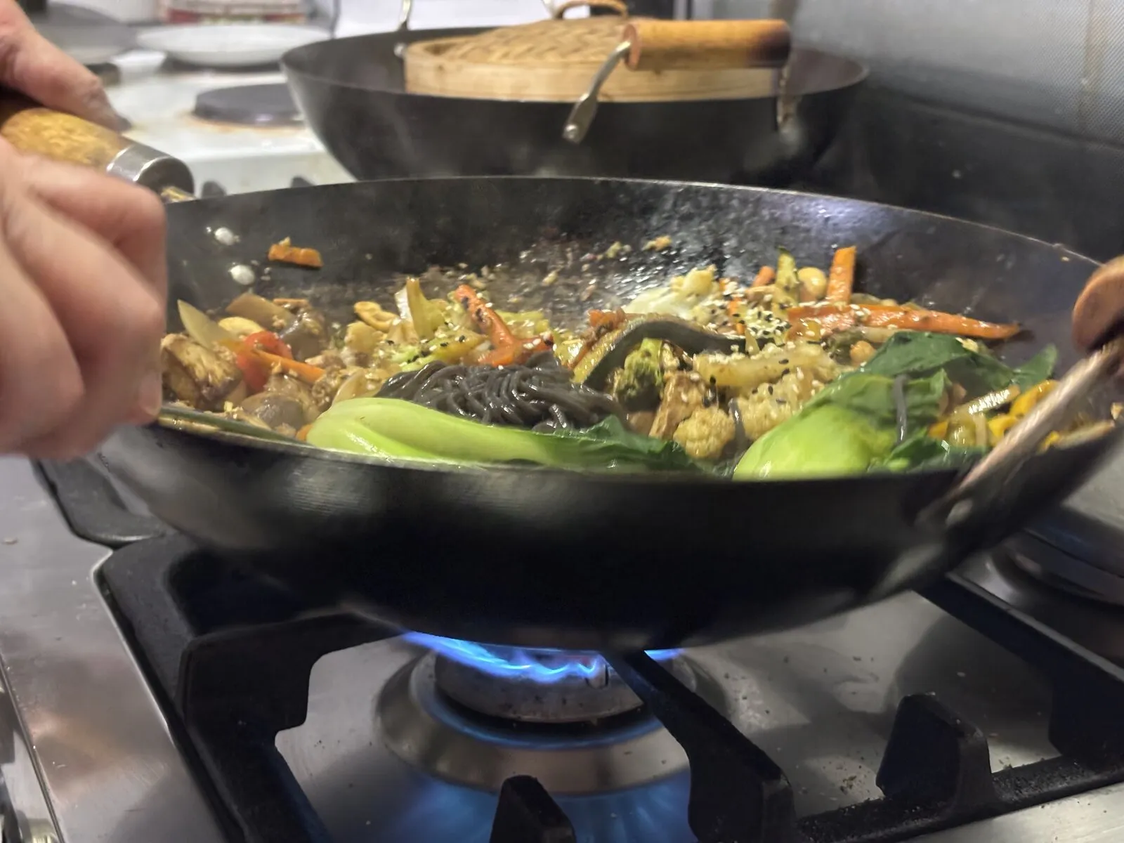 Wok stir-fry on the flame at The Seedling Kitchen